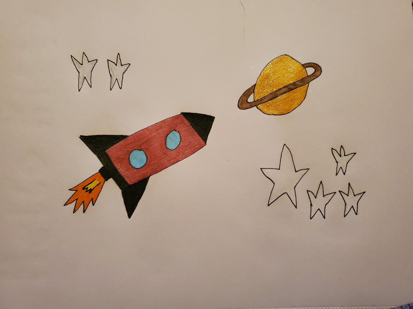 A rocket, stars and saturn