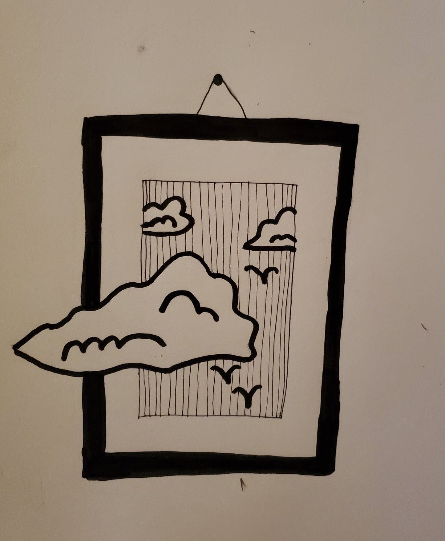 Framed picture of birds and clouds