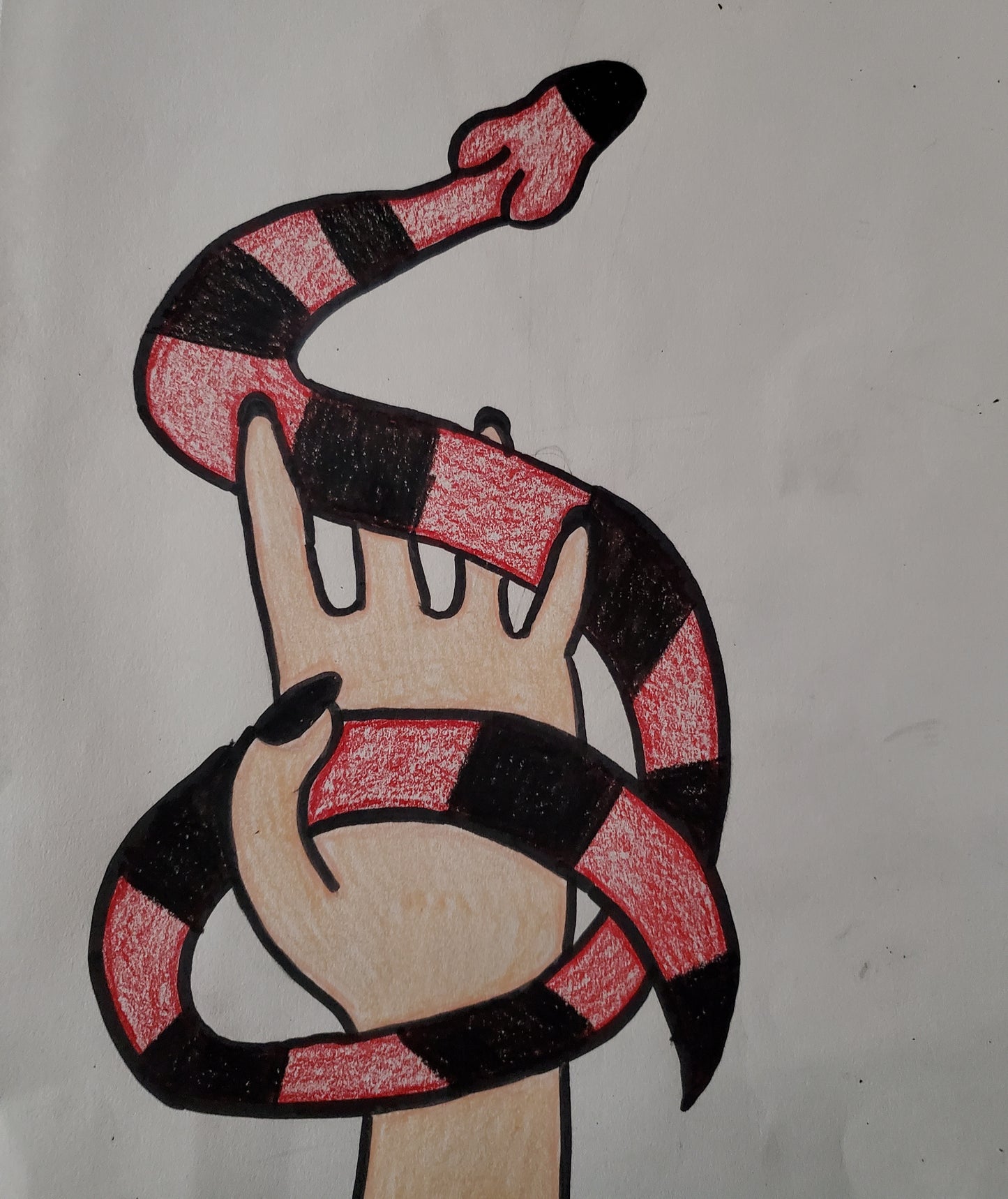 A hand holding a snake