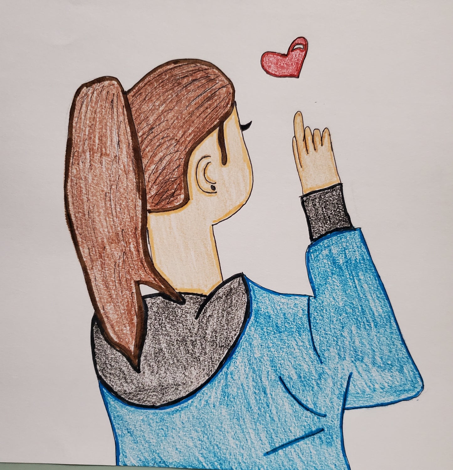 A girl pointing at a heart