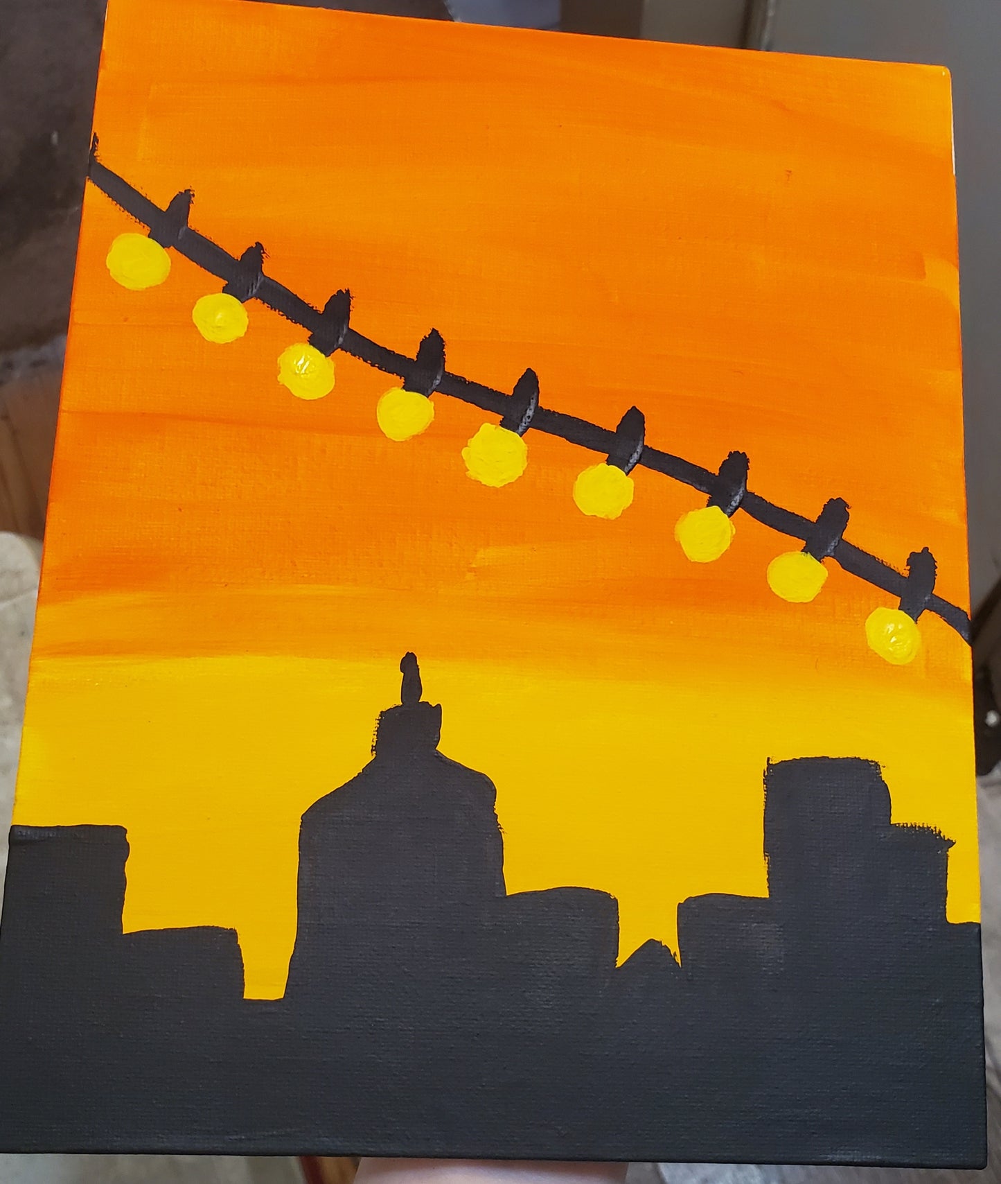 Painting of a city with lights above