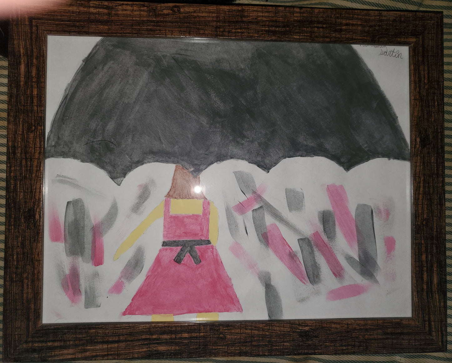 A framed painting I did of a girl holding an umbrella