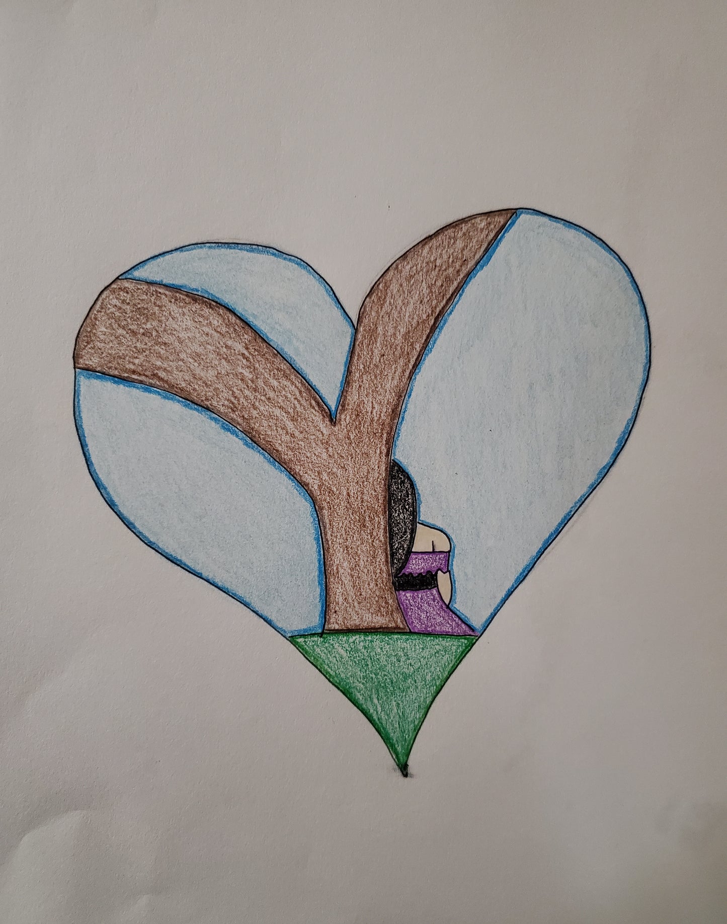 A girl sitting against a tree