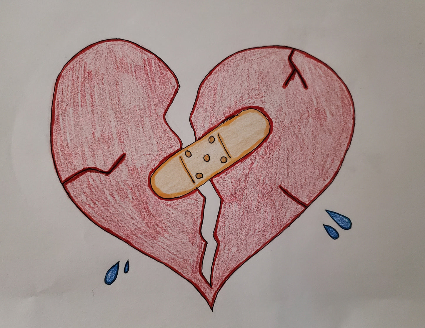 A broken heart being put back together by a bandaid