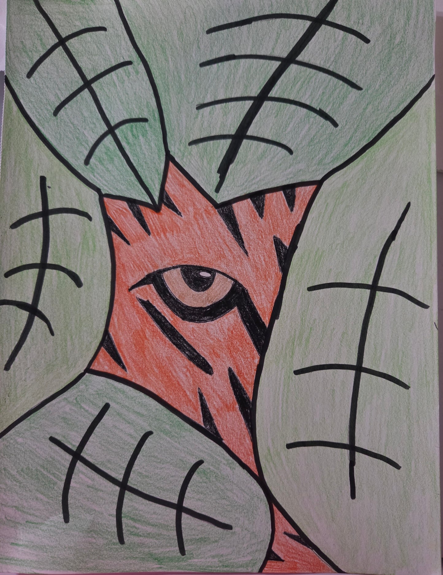 A tiger peaking through the leaves